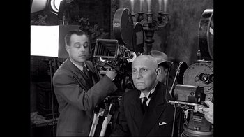 Movie still from “Side by Side” (2012), directed by Christopher Kenneally – An old photo of a man sitting in front of a camera; Medium shot, Low angle