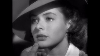 Movie still from “Side by Side” (2012), directed by Christopher Kenneally – A black - and - white photo of a woman in a hat; Close Up shot, Over the shoulder angle