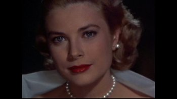 Movie still from “Side by Side” (2012), directed by Christopher Kenneally – A woman wearing pearls and a white dress; Close Up shot, Low angle