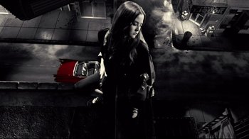 Movie still from “Side by Side” (2012), directed by Christopher Kenneally – A woman in black jacket holding a purse; Wide shot, Overhead angle