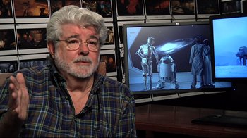 Movie still from “Side by Side” (2012), directed by Christopher Kenneally – A man sitting in front of a television; Close Up shot, Over the shoulder angle