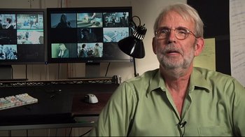 Movie still from “Side by Side” (2012), directed by Christopher Kenneally – An older man sitting in front of a computer monitor; Close Up shot, High angle