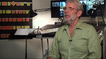 Movie still from “Side by Side” (2012), directed by Christopher Kenneally – An older man sitting in front of a computer keyboard; Medium shot, Over the shoulder angle