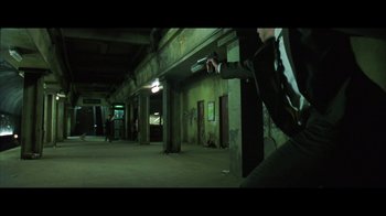 Movie still from “Side by Side” (2012), directed by Christopher Kenneally – A person is jumping in the air with a skateboard in the dark; Wide shot, Low angle