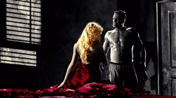 Movie still from “Side by Side” (2012), directed by Christopher Kenneally – A man and a woman are standing on a bed; Medium shot, Over the shoulder angle