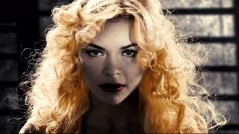 Movie still from “Side by Side” (2012), directed by Christopher Kenneally – A beautiful woman with blonde hair and red lipstick; Close Up shot, Low angle