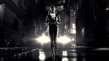 Movie still from “Side by Side” (2012), directed by Christopher Kenneally – A black and white photo of a woman walking down the street; Wide shot, Low angle
