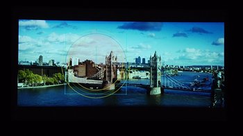 Movie still from “Side by Side” (2012), directed by Christopher Kenneally – A picture of a bridge and a city with a golden circle in the middle of the picture; Extreme Close Up shot, Overhead angle