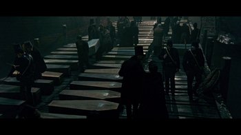 Movie still from “Side by Side” (2012), directed by Christopher Kenneally – A group of people standing on a wooden platform; Wide shot, High angle