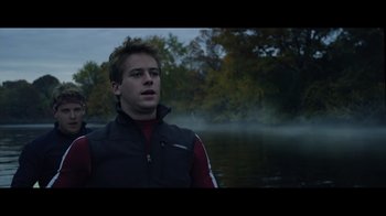 Movie still from “Side by Side” (2012), directed by Christopher Kenneally – A man standing in front of a body of water; Close Up shot, Low angle