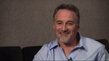 Movie still from “Side by Side” (2012), directed by Christopher Kenneally – A person sitting in a chair; Close Up shot, Over the shoulder angle