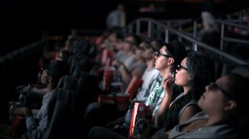 Movie still from “Side by Side” (2012), directed by Christopher Kenneally – A group of people sitting in a row watching a movie; Wide shot, High angle