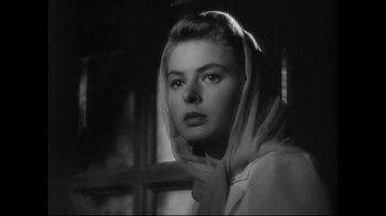 Movie still from “Side by Side” (2012), directed by Christopher Kenneally – A black - and - white photo of a woman wearing a head scarf; Close Up shot, Low angle