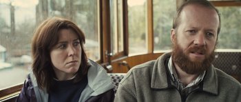 Movie still from “Sightseers” (2012), directed by Ben Wheatley – A man and a woman sitting next to each other; Close Up shot, Over the shoulder angle