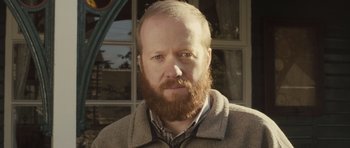 Movie still from “Sightseers” (2012), directed by Ben Wheatley – A man with a red beard is looking at the camera; Close Up shot, Low angle