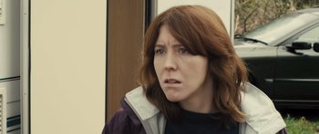 Movie still from “Sightseers” (2012), directed by Ben Wheatley – A person wearing a jacket; Close Up shot, Over the shoulder angle