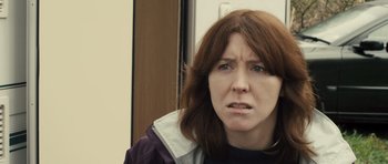 Movie still from “Sightseers” (2012), directed by Ben Wheatley – A person wearing a jacket; Close Up shot, Over the shoulder angle