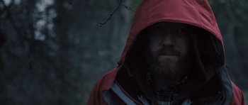 Movie still from “Sightseers” (2012), directed by Ben Wheatley – A man with a beard wearing a red rain jacket; Close Up shot, Low angle