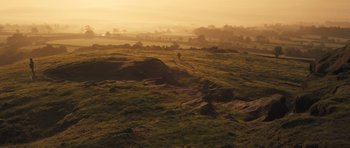 Movie still from “Sightseers” (2012), directed by Ben Wheatley – The sun is setting over a grassy field; Extreme Wide shot, Low angle