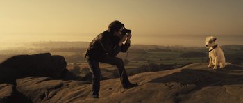 Movie still from “Sightseers” (2012), directed by Ben Wheatley – A man taking a picture on top of a hill; Wide shot, Low angle