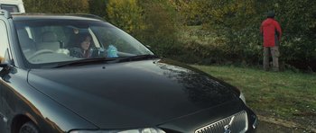 Movie still from “Sightseers” (2012), directed by Ben Wheatley – A black car parked on the side of the road; Wide shot, Low angle