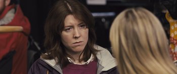 Movie still from “Sightseers” (2012), directed by Ben Wheatley – A woman is looking at the camera while talking to another woman; Close Up shot, Over the shoulder angle