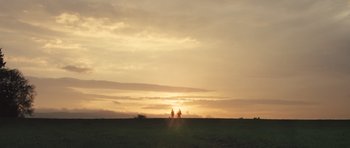 Movie still from “Sightseers” (2012), directed by Ben Wheatley – Two people are standing in a field at sunset; Extreme Wide shot, Low angle