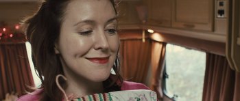 Movie still from “Sightseers” (2012), directed by Ben Wheatley – A person wearing a pink shirt; Close Up shot, Over the shoulder angle