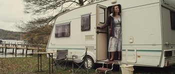 Movie still from “Sightseers” (2012), directed by Ben Wheatley – A woman standing in the doorway of a camper; Wide shot, Low angle