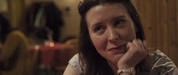 Movie still from “Sightseers” (2012), directed by Ben Wheatley – A person sitting in front of a table; Close Up shot, Over the shoulder angle