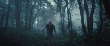 Movie still from “Sightseers” (2012), directed by Ben Wheatley – A man standing in the middle of a forest; Wide shot, Low angle