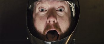 Movie still from “Sightseers” (2012), directed by Ben Wheatley – A man with a beard wearing a helmet; Extreme Close Up shot, Overhead angle