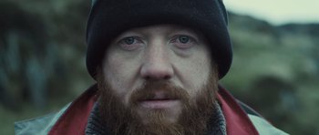 Movie still from “Sightseers” (2012), directed by Ben Wheatley – A person with a beard wearing a hat; Extreme Close Up shot, Low angle