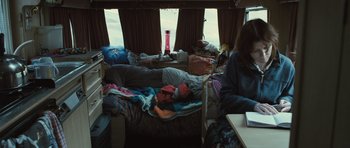 Movie still from “Sightseers” (2012), directed by Ben Wheatley – A couple of people laying on a bed in a room; Wide shot, High angle