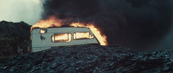 Movie still from “Sightseers” (2012), directed by Ben Wheatley – A fire is burning in the background of this picture; Extreme Wide shot, Low angle