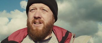 Movie still from “Sightseers” (2012), directed by Ben Wheatley – A person with a beard wearing a hat; Close Up shot, Low angle