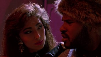 Movie still from “Sign 'o' the Times” (1987), directed by Albert Magnoli – A man and a woman are looking at one another; Close Up shot, Low angle