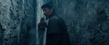 Movie still from “Silence” (2016), directed by Martin Scorsese – A man and a woman walking down a dark alley; Medium shot, Over the shoulder angle