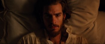 Movie still from “Silence” (2016), directed by Martin Scorsese – A person with long hair and a beard; Close Up shot, High angle