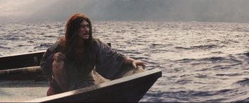 Movie still from “Silence” (2016), directed by Martin Scorsese – A man in a boat in the middle of the ocean; Medium shot, Low angle