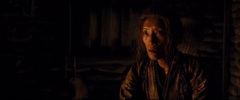 Movie still from “Silence” (2016), directed by Martin Scorsese – A woman in a dimly - lit room looking at the camera; Close Up shot, Over the shoulder angle