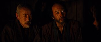 Movie still from “Silence” (2016), directed by Martin Scorsese – A man with a beard wearing a brown robe; Close Up shot, Over the shoulder angle