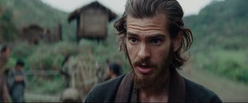 Movie still from “Silence” (2016), directed by Martin Scorsese – A person with long hair and a beard; Close Up shot, Over the shoulder angle