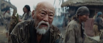Movie still from “Silence” (2016), directed by Martin Scorsese – An old man with a beard is looking into the distance; Close Up shot, Low angle