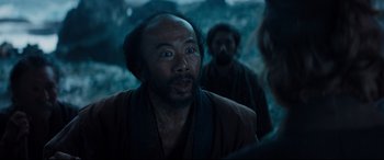 Movie still from “Silence” (2016), directed by Martin Scorsese – A man with a beard is looking into the distance; Close Up shot, Over the shoulder angle