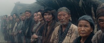 Movie still from “Silence” (2016), directed by Martin Scorsese – A group of people standing next to each other; Medium shot, Low angle