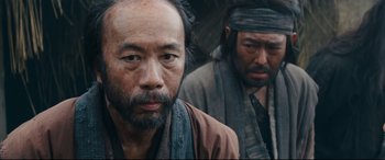 Movie still from “Silence” (2016), directed by Martin Scorsese – Two asian men standing next to each other; Close Up shot, Over the shoulder angle