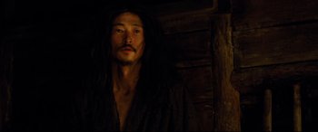 Movie still from “Silence” (2016), directed by Martin Scorsese – A man with long black hair wearing a black robe; Close Up shot, Over the shoulder angle