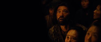 Movie still from “Silence” (2016), directed by Martin Scorsese – A man with long hair and a beard is looking up; Close Up shot, Over the shoulder angle