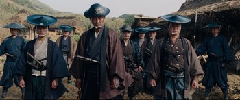 Movie still from “Silence” (2016), directed by Martin Scorsese – A group of men in traditional japanese garb and hats; Medium shot, Low angle